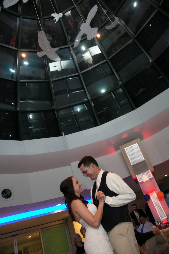 Lauren and Eli enjoy their first dance under the Atrium at the National Aviary.