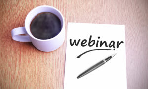 Coffee on the table with note writing webinar