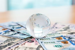 Glass globe and US dollar bills Glass globe and US dollar bills.