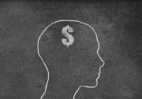 Female Head Shape with dollar sign on a Blackboard